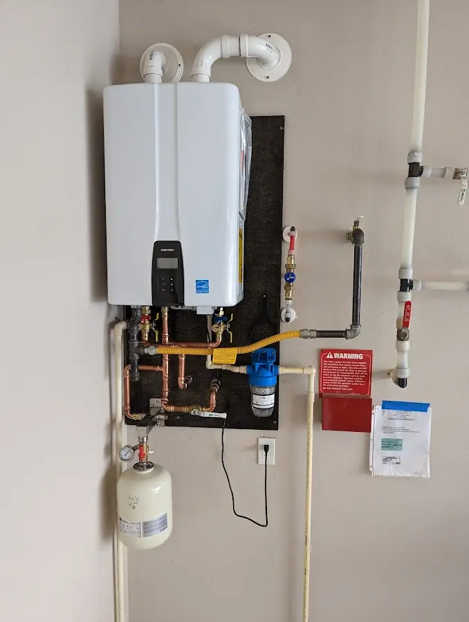 Professional plumber installing copper piping in a Brandon home